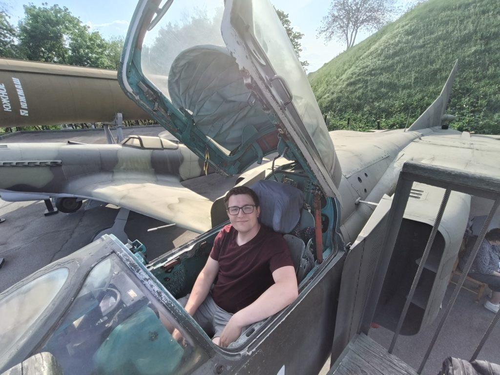 Tourist sitting in a military aircraft
